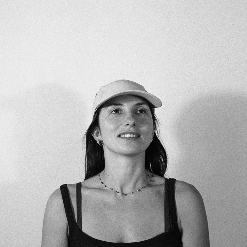 Portrait of Agathe Trouette in a cap, smiling, black and white